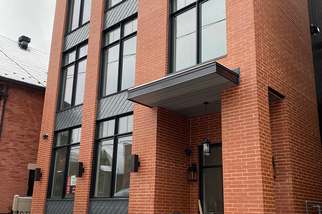 Metal-clad building exterior showing clean panel lines and trim