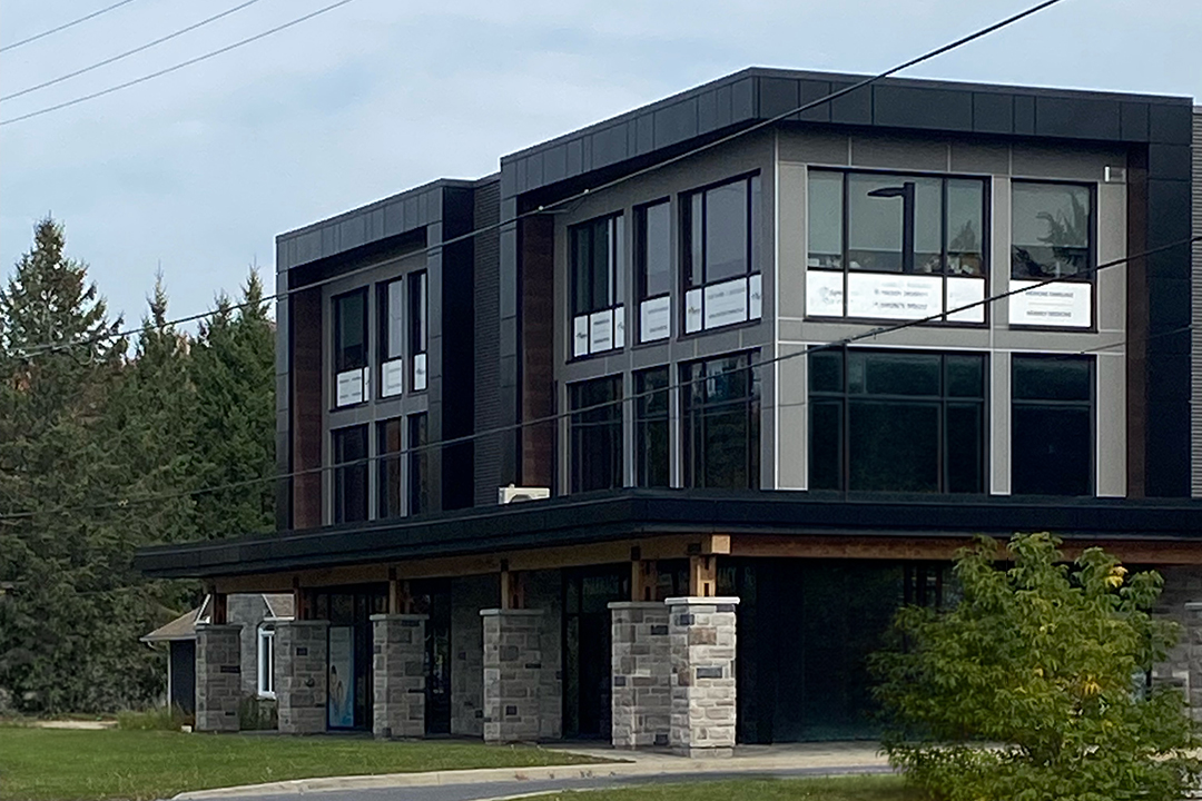 Modern commercial building with storefront and upper-level office space